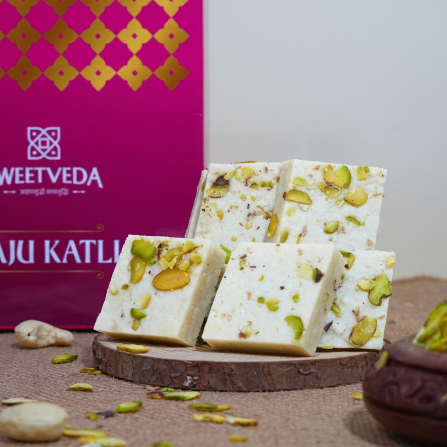 Sweet treats with pistachios on a wooden board in front of a Sweetveda box.