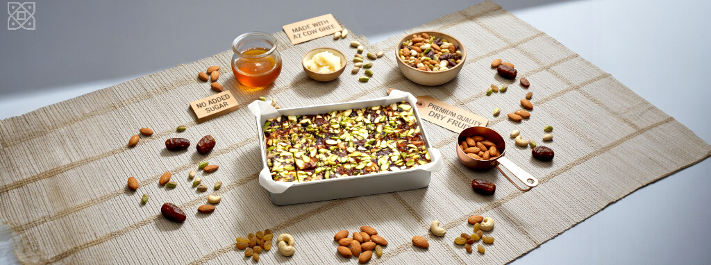 Assorted nuts and seeds on a woven mat with small bowls and cups.