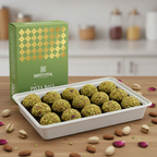 Tray of Gulkand Laddu with a Sweetveda box on a wooden surface