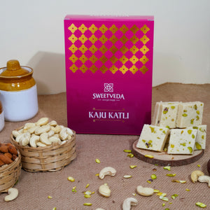 Sweetveda Kaju Katli packaging with cashews and katli on a brown surface