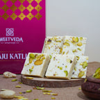 Sweet treats with pistachios on a wooden board in front of a Sweetveda box.