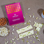 Sweetveda Kaju Katli with cashew nuts and almonds on a textured surface